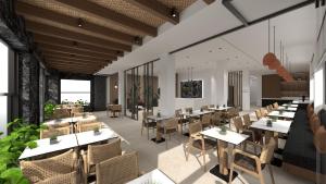 Un restaurante con mesas y sillas en una sala. en Anesea City, en Heraklion