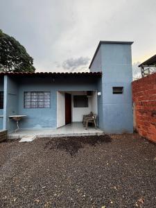 a blue house with a bench in front of it at Microcasa 02 in Tangara da Serra