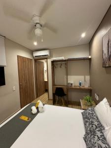 a bedroom with a large bed and a desk at Casa Roman Hotel Boutique in Cartagena de Indias