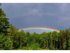 a rainbow in the sky over a forest at Authentic Tipi Set in the Stunning Woodland of the White Mountain National Forest, New Hampshire in Chatham +15 photos