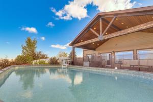 a swimming pool in front of a house at Private Hot Tub and Game Room Keenesburg Getaway! in Hudson