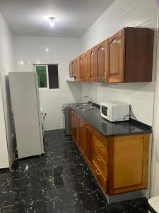a kitchen with a counter and a white refrigerator at Zeapart in Praia