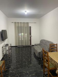 a living room with a couch and a tv at Zeapart in Praia