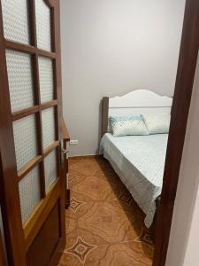 a bedroom with a bed and a door leading into a room at Zeapart in Praia