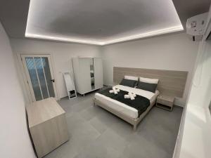 a bedroom with a bed with two stuffed animals on it at Brand New Seafront Apartment in Sliema