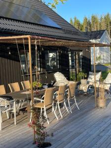 a patio with a table and chairs on a deck at Villa Golfgatan 32 Vintrosa Lanna in Vintrosa