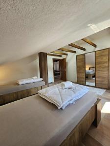 a bedroom with two beds and a large mirror at Visoko Luxury Residence in Biskupići
