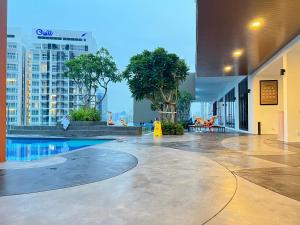 an empty lobby of a building with a swimming pool at Gen Majestic Residence Kuala Lumpur in Kuala Lumpur