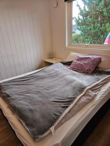 a large bed in a room with a window at Luxury apartment in Stavanger in Stavanger