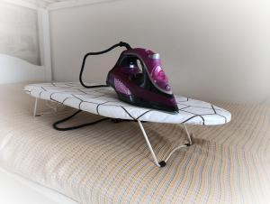a room with a bed with a iron on a bed frame at Antico Gelso in Polignano a Mare