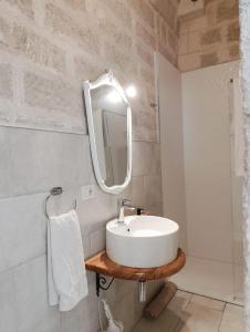 a bathroom with a sink and a mirror at Antico Gelso in Polignano a Mare +46 photos