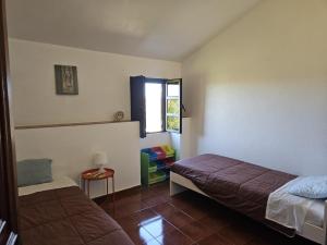 a bedroom with two beds and a window at Nisa 2 Bedrooms AC Villa in Nisa