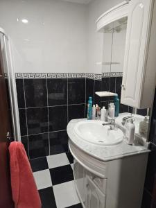 a bathroom with a sink and a black and white checkered floor at Nisa 2 Bedrooms AC Villa in Monte Claro +33 photos