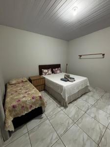 a bedroom with a bed in a room with at Casa ampla e confortavel in Tangara da Serra