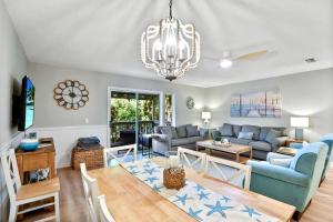 a living room with a couch and a table at Salt Shack in Saint Simons Island