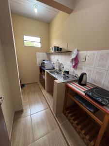 Una pequeña cocina con fregadero y estufa. en Confort moderno, cerca de todo, en Fernando de la Mora