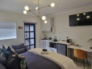 a living room with a couch and a kitchen at Alice in Wonderland in Kimberley