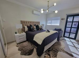 a bedroom with a bed and a zebraebra rug at Alice in Wonderland in Kimberley