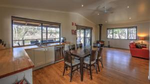a kitchen and dining room with a table and chairs at Tiny Away Escape at Granite Belt - Sommerville Valley in Stanthorpe