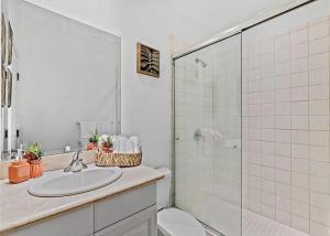 a white bathroom with a sink and a shower at Pacifico L1115 in Coco +17 photos
