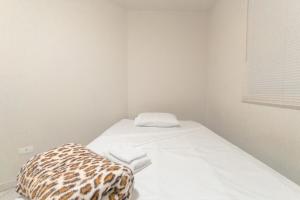 a room with a bed with a leopard print pillow at Apartamento Economico - GI02 in Maringá
