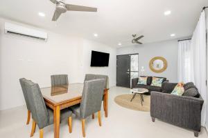 a dining room and living room with a table and chairs at Los Mangos #3 in Coco