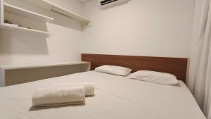 a bedroom with a bed with two towels on it at Miray Exclusive - Praia dos Carneiros in Praia dos Carneiros +16 photos