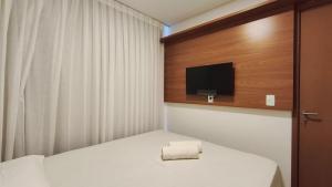a small room with a bed and a tv at Miray Exclusive - Praia dos Carneiros in Praia dos Carneiros