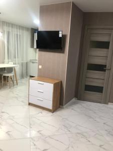 a living room with a flat screen tv on a wall at Одеська 129 in Golta