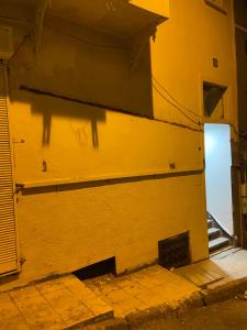 a yellow wall with a door and a doorway at HOmE SUITE in Istanbul
