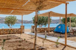 a tent on the beach with a view of the water at Coralli Camping in Livadakia