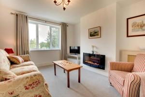 a living room with a couch and a table at Scarbeck House in Masham