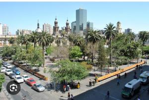 a city with cars parked in a parking lot at Catedral Centro in Santiago