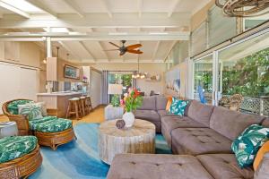 a living room with a couch and a table at Ocean View Cottage Wlk To Poipu & Brenneckes Beach in Koloa