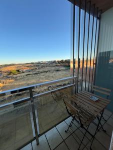 a bench on a balcony with a view of the ocean at El Rincón del Marqués in Las Navas del Marqués +8 photos