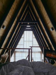 una cama en una habitación con una ventana grande en Cabana UaiMeo, en Senador Amaral