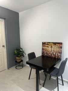 a dining room with a black table and chairs at JRMN Property in Sint Michiel