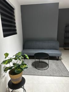 a living room with a couch and a table at JRMN Property in Sint Michiel