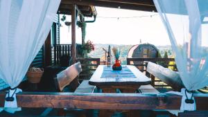a wooden table and chairs on a deck with a view at Holiday Home Hygge Nova in Grabrovnik