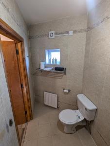 a small bathroom with a toilet and a window at City Centre A Apartment, 2nd Floor in Belfast +15 photos