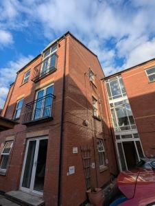 a red brick building with windows on the side of it at City Centre A Apartment, 2nd Floor in Belfast