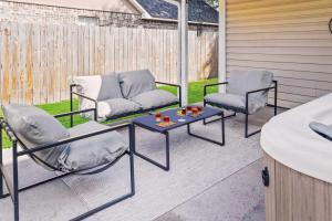 two chairs and a table on a patio at Endless Summer Retreat with Private Pool near Beach in Gautier