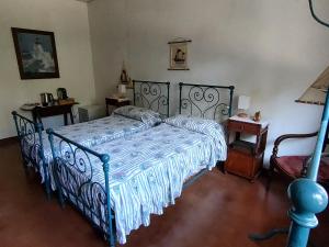 ein Schlafzimmer mit einem Bett mit einer blau-weißen Bettdecke in der Unterkunft La Casa dei Pini in Marina Romea
