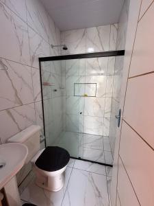 a bathroom with a shower with a toilet and a sink at Recanto Enseada dos Corais in Cabo de Santo Agostinho
