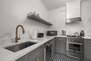 a kitchen with a sink and a stove at The Adaline Room #8 - Beautiful Hyde Park Apt, 2nd Floor, Steps to Bayshore in Tampa +38 photos