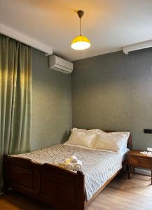 a bedroom with a bed with two teddy bears on it at ILIAS Guest House in Kvareli