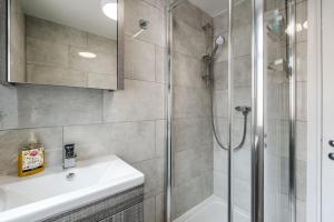 a bathroom with a shower and a sink at Franks house, 3 Bedroom in Liverpool - sleeps 5, Newly refurbished - long stays welcome, free parking in Litherland +20 photos