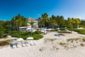 an aerial view of a beach with chairs and umbrellas at 7 bedroom plantation estate Villa in Leeward