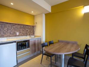 a kitchen with a table and chairs in a room at Solar das Águas Park Resort in Olímpia