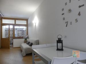a living room with a white couch and a table at Alloggio "a casa di Gió" in Tuscania